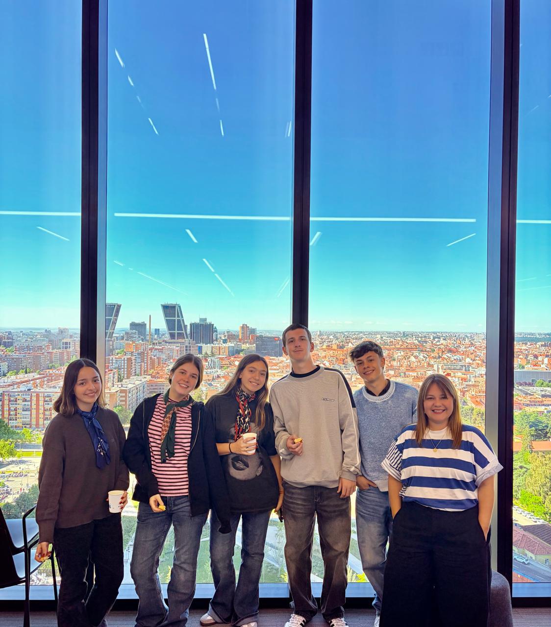 Students by the window with Madrid skyline view